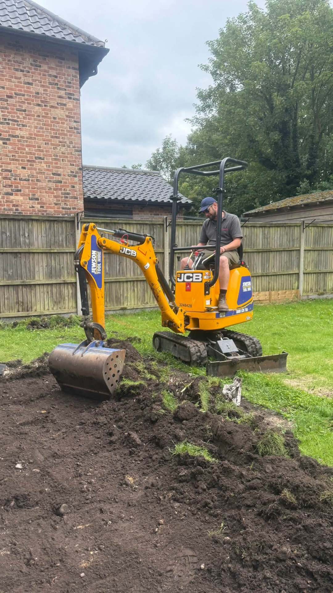 B.I.G Fellers crew operating a mini-digger on a landscaping job